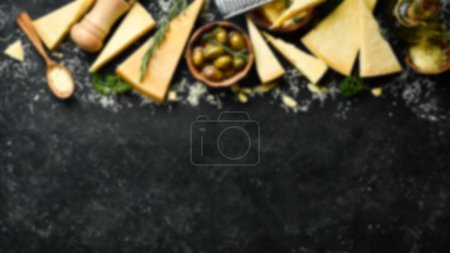 Photo for Defocused food background. Set of hard cheeses with cheese knives on black stone background. Parmesan. Top view. Free space for your text. - Royalty Free Image