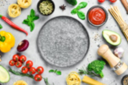 Photo for Defocused food background. Gray stone cooking background. Spices and vegetables. Top view. Free space for your text. - Royalty Free Image