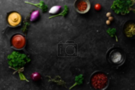 Photo for Defocused food background. Black stone cooking background. Spices and vegetables. Top view. Free space for your text. - Royalty Free Image