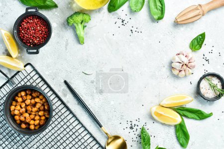 Photo for Cooking background: chickpeas, spices, and herbs. On a concrete background. Top view. - Royalty Free Image