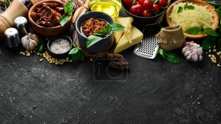 Photo for Pesto sauce with sun-dried tomatoes in a bowl. Traditional Italian sauce. On a concrete background. - Royalty Free Image
