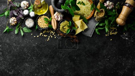 Photo for Pesto sauce. Ingredients for making pesto. On a black stone background. Top view. - Royalty Free Image