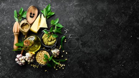 Photo for Pesto sauce. Ingredients for making pesto. On a black stone background. Top view. - Royalty Free Image