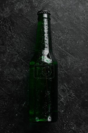 Photo for Fresh hop, glasses and beer. Light beer in glass bottles on a black stone background. Beer banner. - Royalty Free Image