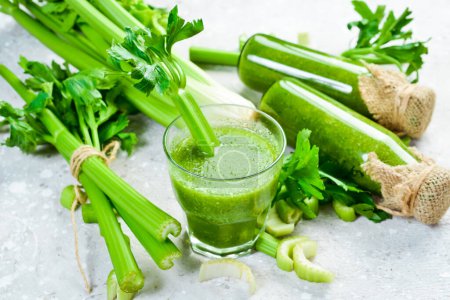 Photo for Vegetarian detox diet green smoothies with fresh celery, spinach, natural orange juice on a dark background. Healthy food. Free space for text. - Royalty Free Image