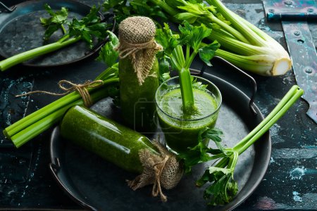Photo for Celery smoothie and fresh celery on a stone background. Healthy food. Free space for text. - Royalty Free Image