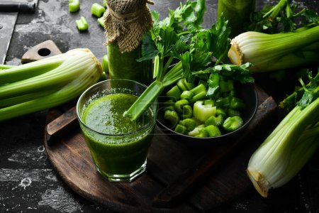 Photo for Celery smoothie and fresh celery on a stone background. Healthy food. Free space for text. - Royalty Free Image