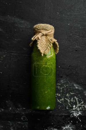 Foto de Batido de verduras y frutas verdes con kiwi, espinacas, manzana y apio en una botella. Comida vegana. Espacio libre para texto. - Imagen libre de derechos