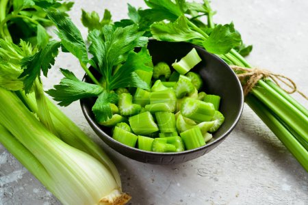 Celery stalk cut into pieces in a bowl. Vegan food. Free space for text.