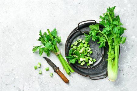 Photo for Celery. Preparation of celery for cooking dietary dishes. Healthy food. Top view. Free space for text. - Royalty Free Image