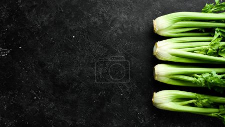 Photo for Celery stalk with green leaves. Organic healthy food on stone background. Top view. Free space for text. - Royalty Free Image
