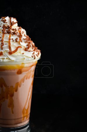 Photo for Chocolate milkshake in a plastic cup. on a black background. Free space for text. - Royalty Free Image