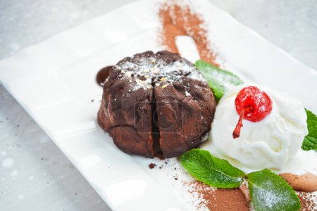 Photo for Chocolate fondant cake with ice cream and mint. Top view. Free space for text. - Royalty Free Image