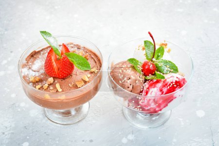 Photo for Balls of chocolate and strawberry ice cream in glasses. Top view. Free space for text. - Royalty Free Image