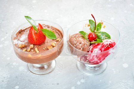 Photo for Balls of chocolate and strawberry ice cream in glasses. Top view. Free space for text. - Royalty Free Image