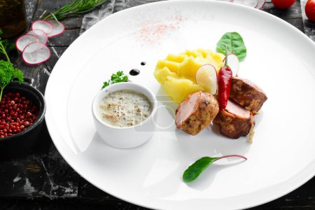 Photo for Fried sausage and mashed potatoes with sauce on a plate. Top view. Free space for text. - Royalty Free Image