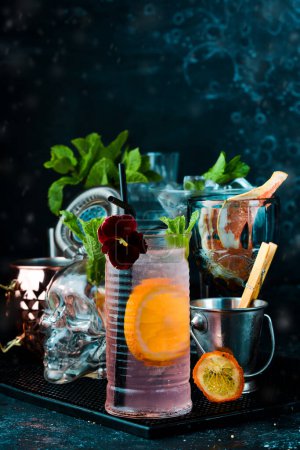 Photo for Lemonade with rose syrup and orange. On a black background. Bar menu. - Royalty Free Image
