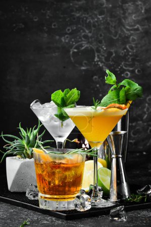 Photo for A set of delicious colored alcoholic cocktails. On a black background. Bar menu. - Royalty Free Image