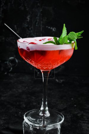 Photo for Raspberry margarita. Cocktail with raspberry liqueur in a glass. Bar menu. On a black background. - Royalty Free Image