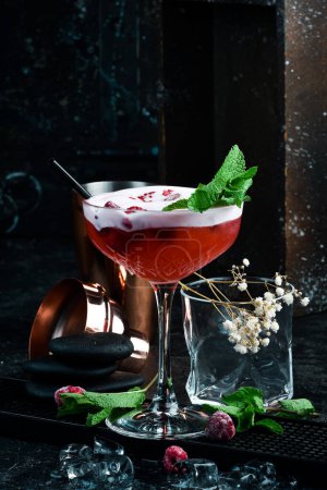 Photo for Raspberry margarita. Cocktail with raspberry liqueur in a glass. Bar menu. On a black background. - Royalty Free Image