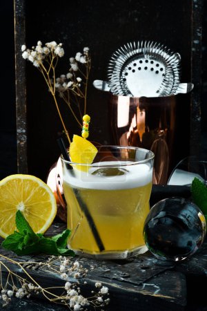Photo for Cocktail. Alcoholic cocktail with lemon liqueur and lemon peel in a glass. Bar menu. - Royalty Free Image