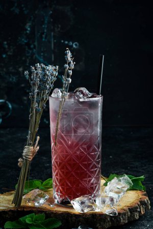 Photo for A cooling drink. Blackberry lemonade with tonic, ice and lavender in a glass. Cocktails. Bar menu. - Royalty Free Image