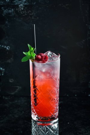 Photo for A cooling drink. Raspberry lemonade with tonic, ice and mint in a glass. Cocktails. Bar menu. - Royalty Free Image