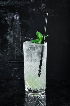 Photo for A cooling drink. Lemonade with lemon, tonic with ice and mint in a glass. Cocktails. Bar menu. - Royalty Free Image