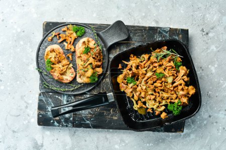Photo for Mushroom dishes and Chanterelle Mushroom Bruschetta. On a stone plate. Free space for text. - Royalty Free Image