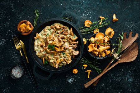 Photo for Mushroom dishes. Cooked chanterelle mushrooms in a cream sauce. Top view. Free space for text. - Royalty Free Image