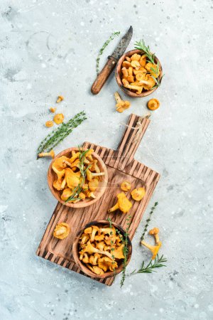Photo for Cooking. Chanterelle mushrooms on the kitchen table are ready to be cooked. Top view. Free space for text. - Royalty Free Image