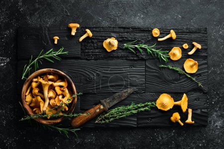 Photo for Chanterelle mushrooms are ready to cook in a bowl. Top view. Free space for text. - Royalty Free Image