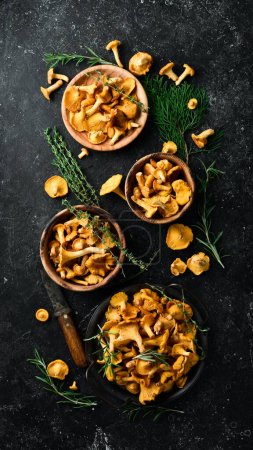 Photo for Chanterelle mushrooms are ready to cook in a bowl. Top view. Free space for text. - Royalty Free Image