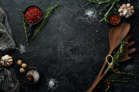 Photo for Kitchen utensils, spices and herbs on a stone background. Cooking concept. Top view. Free space for your text. - Royalty Free Image