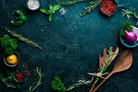 Photo for Kitchen utensils, spices and herbs on a stone background. Cooking concept. Top view. Free space for your text. - Royalty Free Image