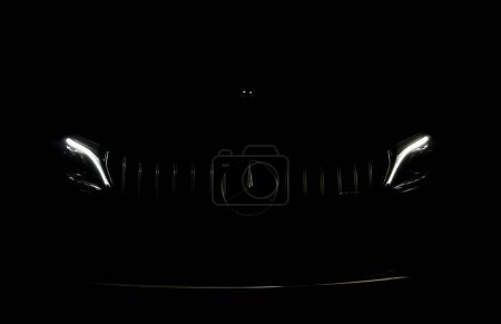 Photo for Headlight led ray of the sports luxury Mercedes Benz c-class c200 coupe AMG dynamic model park in dark garage for checking maintance before delivered to customer - Royalty Free Image