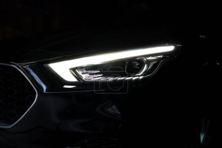 Photo for Headlight led ray of the modern suv MG ZS car model park in the dark garage for checking maintance - Royalty Free Image