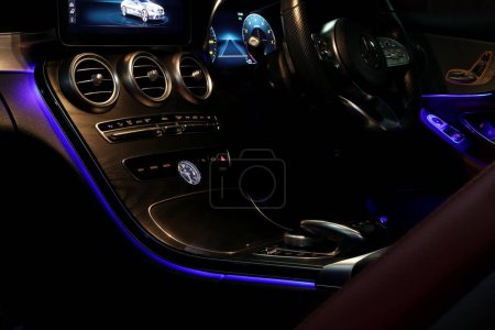 Photo for Car vent ac center console control panel dashboard with blue ambient light of sports car brand Benz c200 coupe amg dynamic model during maintainance checking in the dark garage - Royalty Free Image