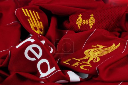 beau maillot de football rouge ou t-shirt de sport de l'équipe du club de Liverpool en ligue première anglaise avec logo du club et logo New Balance sur la table après le port