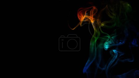 Photo for Rainbow Smoke Curls on Black Background features smoke rising and billowing with rainbow colors moving through a black atmosphere. - Royalty Free Image