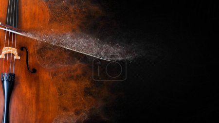 Foto de Fondo de partículas de música de violonchelo presenta una imagen fija de un violonchelo con partículas de color que fluyen lejos del instrumento sobre un fondo de diseño negro. - Imagen libre de derechos
