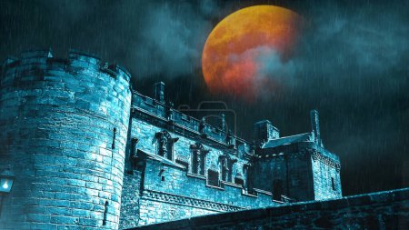 Photo for Castle with Rain Lightning and Blood Moon features a castle ruin with blue clouds and an orange red full moon in the background and mist and rain in the foreground. - Royalty Free Image