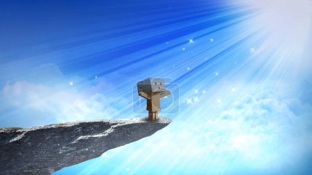 Foto de Carácter de cartón Heavenly Light cuenta con un personaje de caja de cartón de pie en el saliente de un acantilado mirando hacia arriba en los rayos de luz y estrellas que bajan del cielo con nubes detrás y debajo. - Imagen libre de derechos
