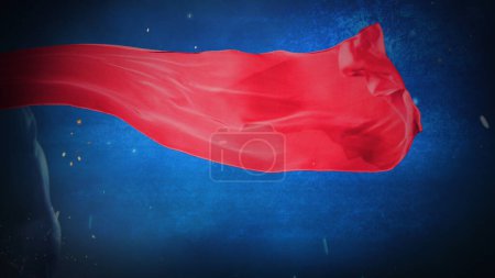 Photo for Super Cape Blue Grunge Wall features a red billowing cape against a blue grunge background and sparks flying and a blue arm and shoulder just visible at the side of the frame. - Royalty Free Image
