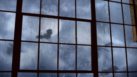 Téléchargez les photos : Scary Bat filled Sky Outside Old Factory Window offre une vue depuis une vieille fenêtre d'usine de nuages roulants et de chauves-souris volant avec une pleine lune. - en image libre de droit