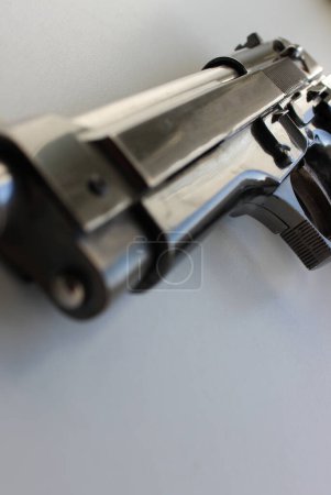 Photo for Barrel Of A Handgun On White Surface With Soft Focus Closeup Stock Photo - Royalty Free Image