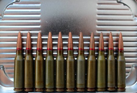 Eleven Bullets In A Row On Corrugated Metal Surface Texture Background