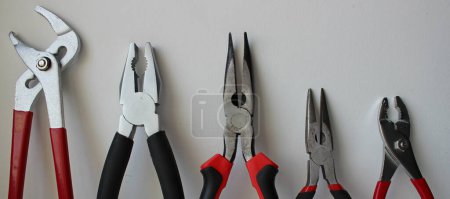 Photo for Top parts of variety types of pliers lined up in size comparison - Royalty Free Image