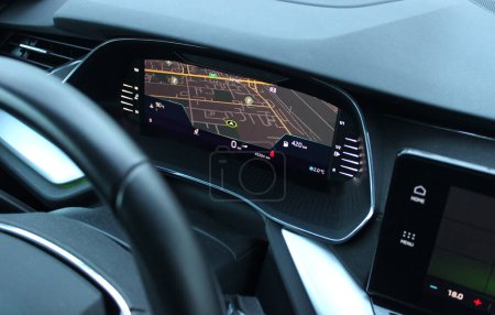 Navigation display on instrument cluster showing the car position on city map top view  