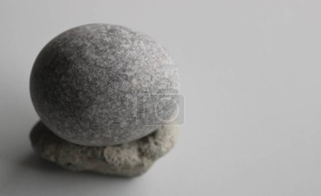 Photo for Single Zen Stone On White Surface At A Side Of Image Stock Photo For Backgrounds - Royalty Free Image